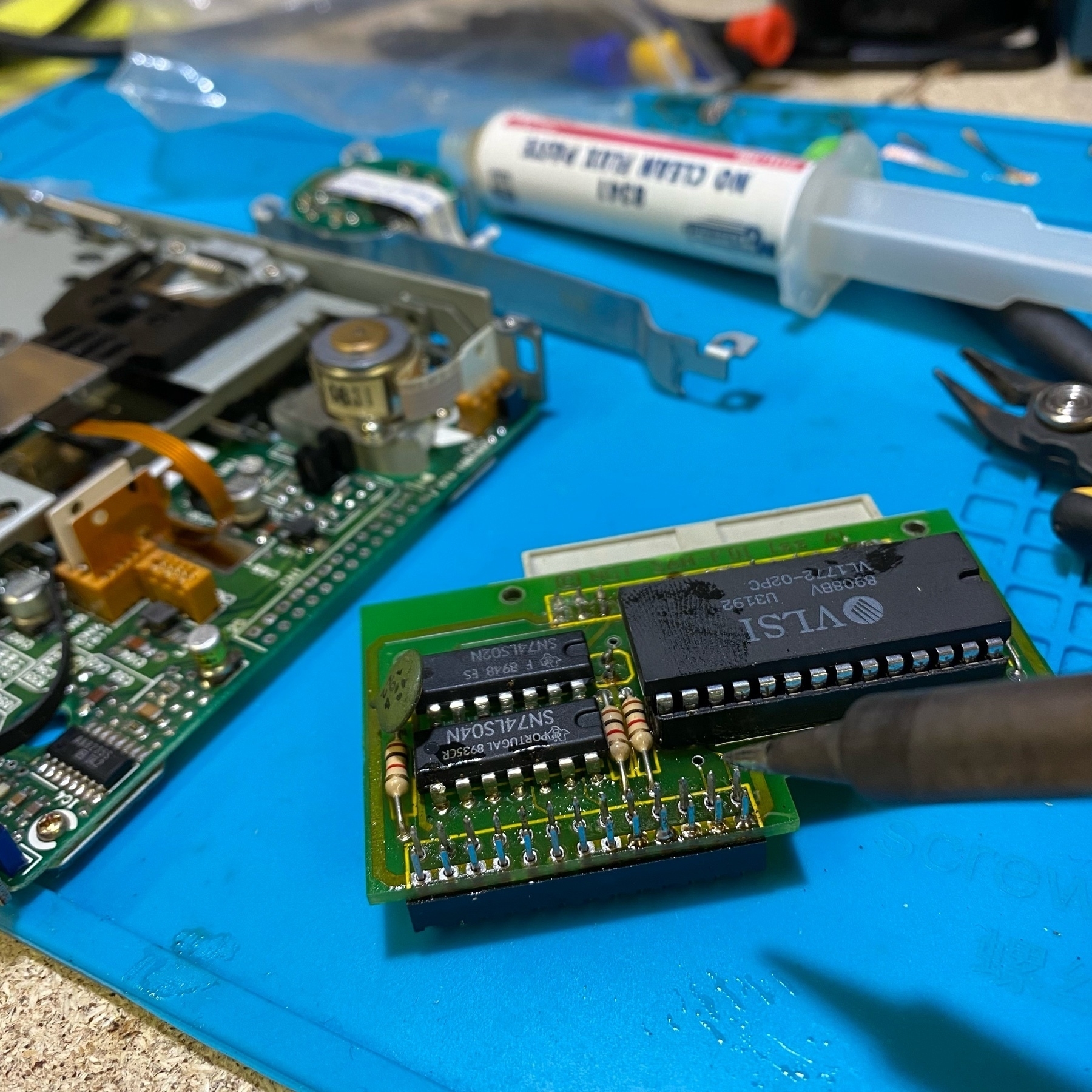 disassembled computer components on a soldering mat