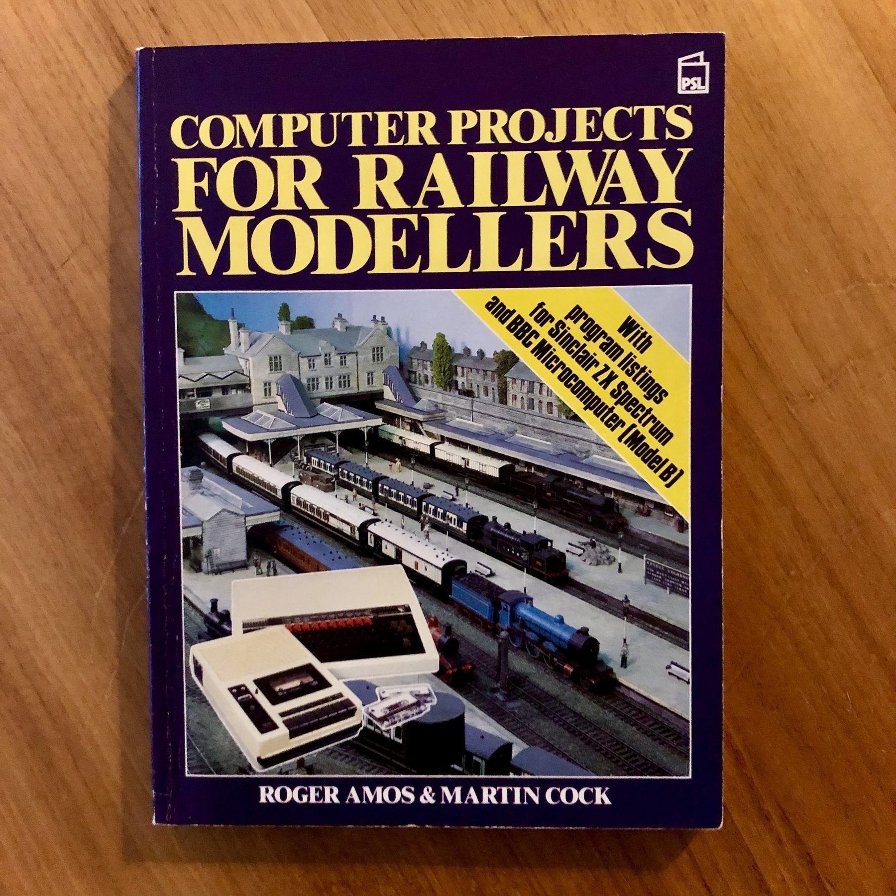 Paperback book. Cover illustration shows a model railway close up, with a BBC Micro superimposed